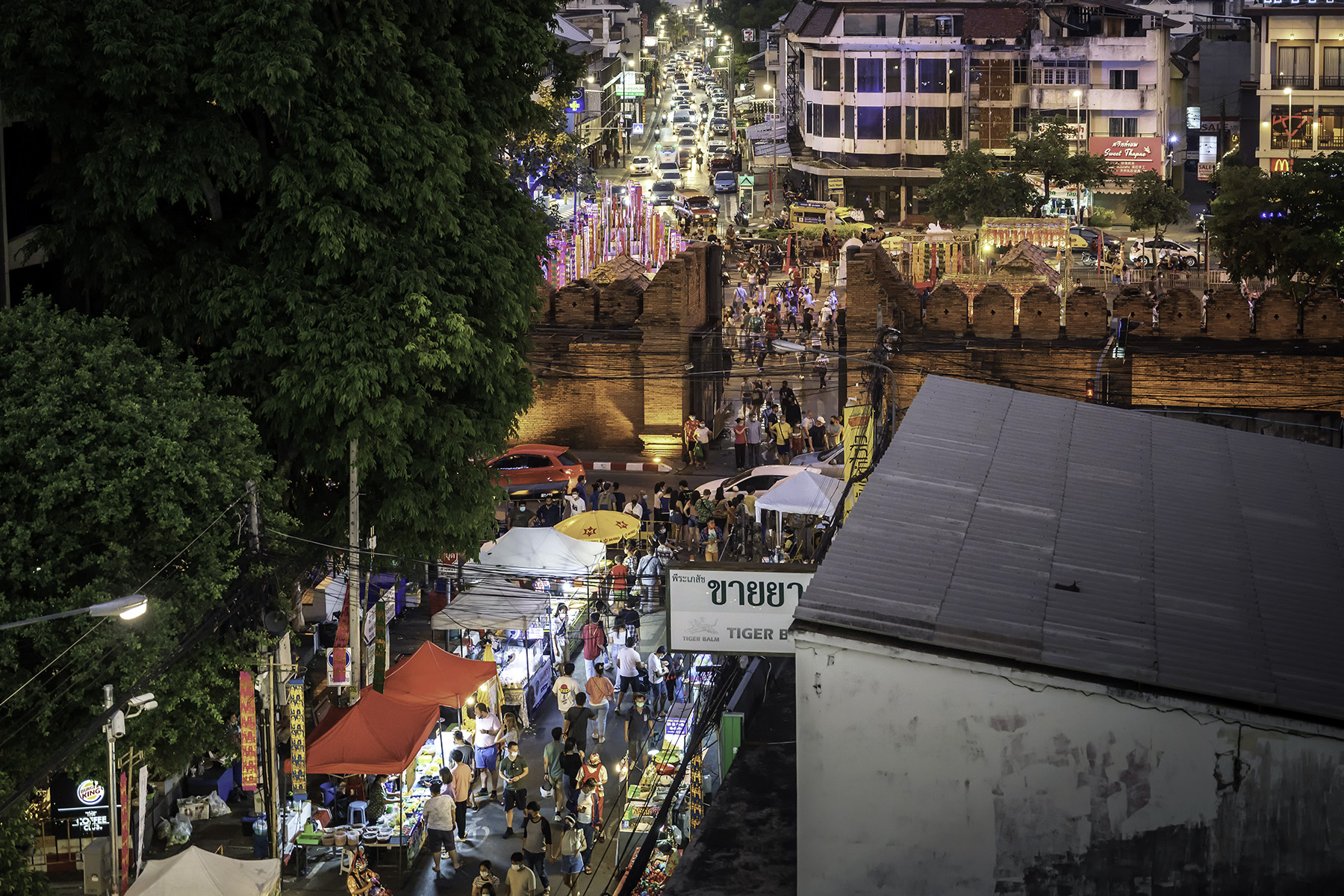 Busy night market at Tha Phae Gate, which marks the east entrance to the old walled city of Chiang Mai, Thailand.