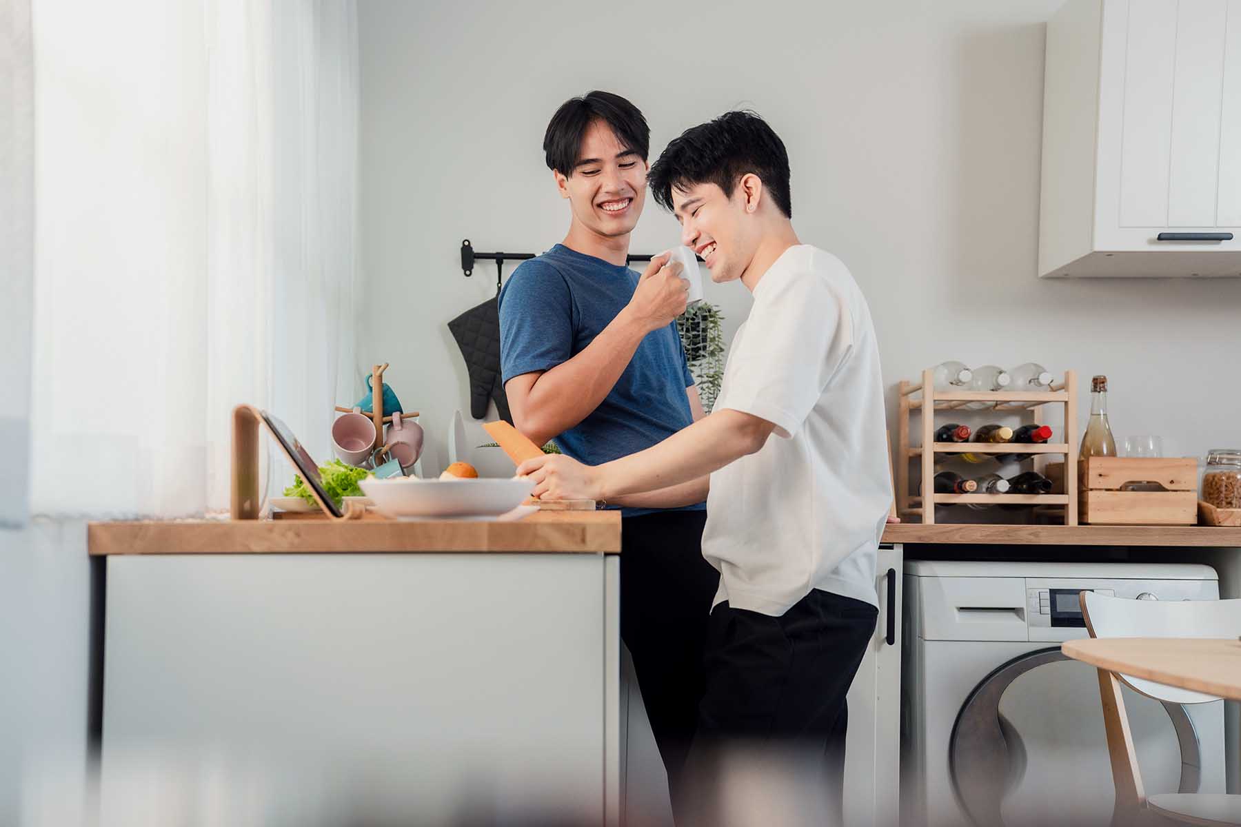A couple in their home's kitchen, cooking a meal together