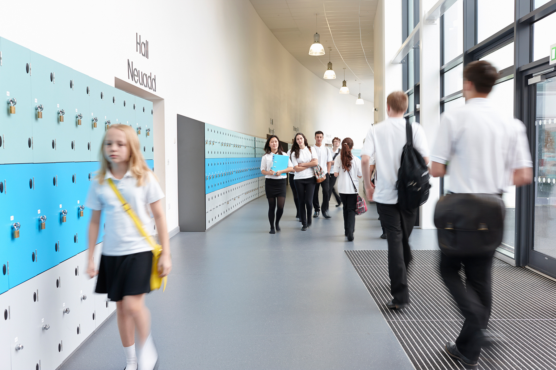 Students walking in a school corridor between lessons