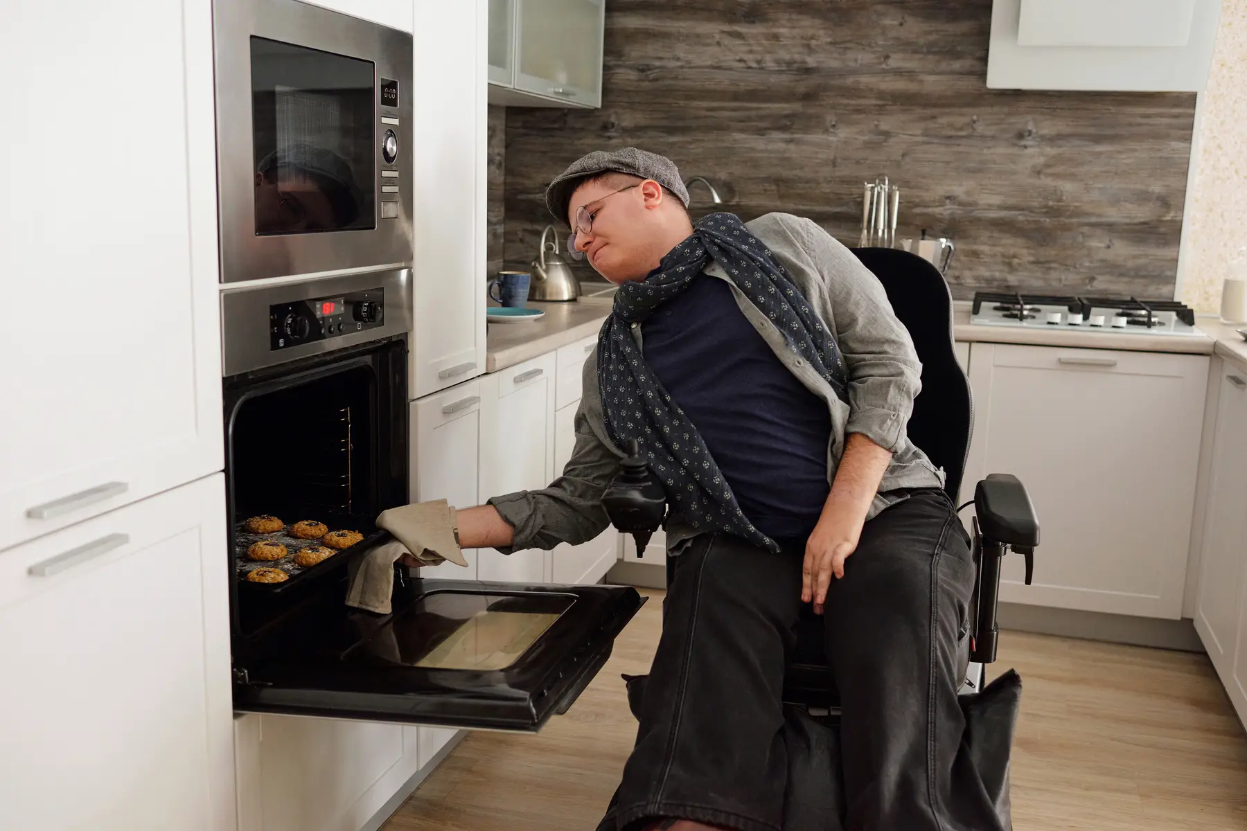 Accessible home: man in wheelchair baking muffins