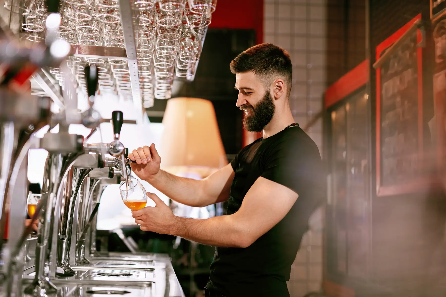 Bearded bartender working in a pub