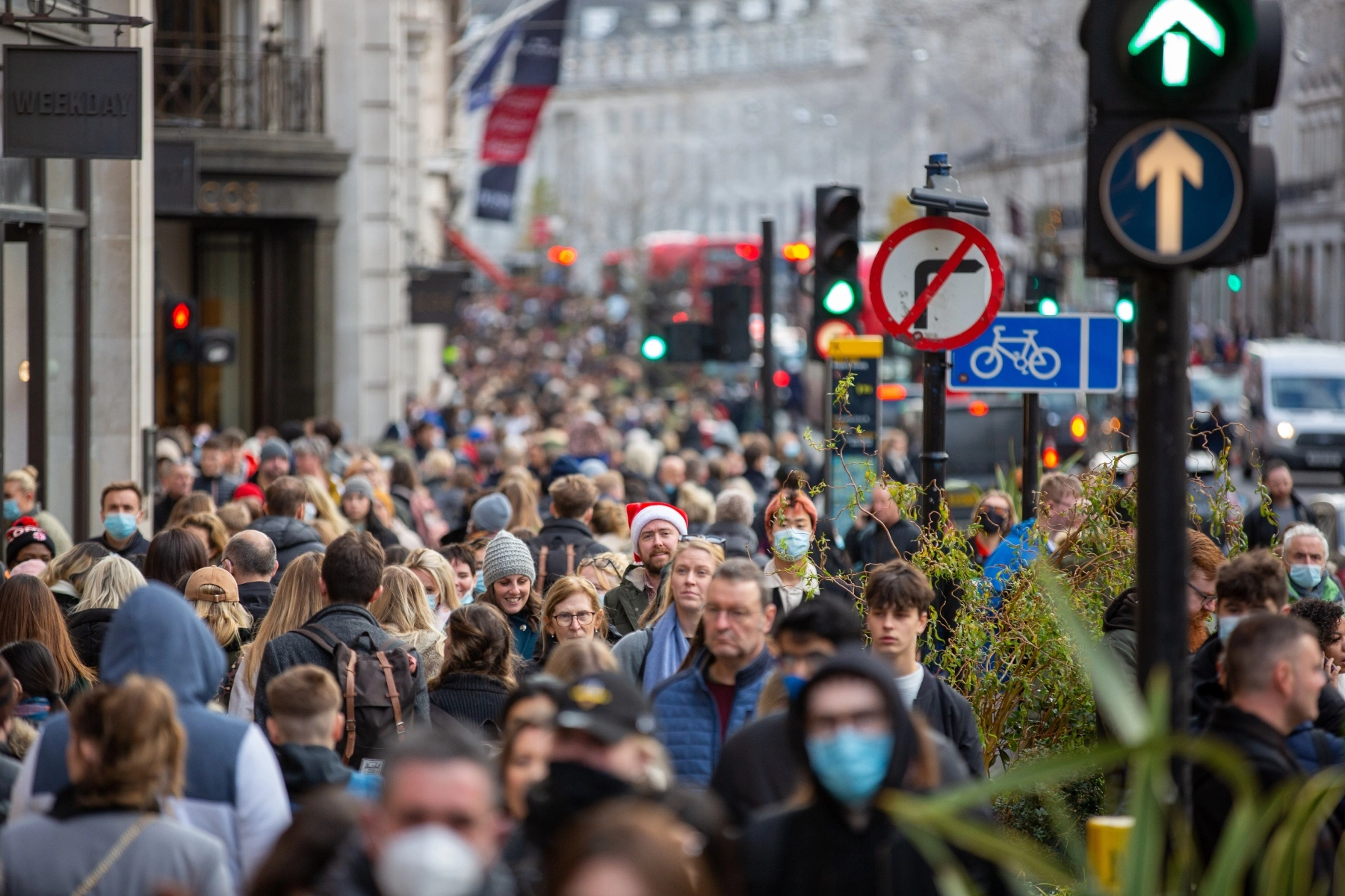 Crowds of people walk down Regent Street in wintertime