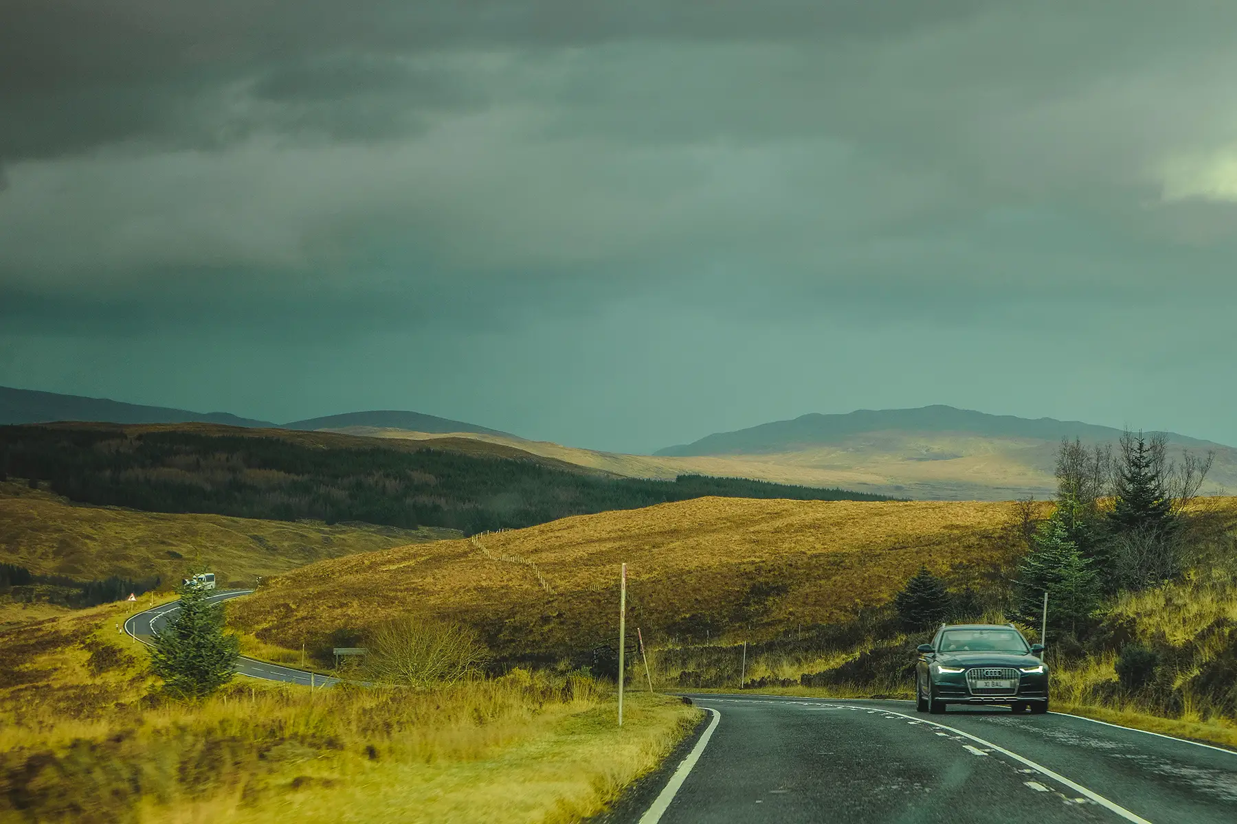 A car driving through rural Scotland
