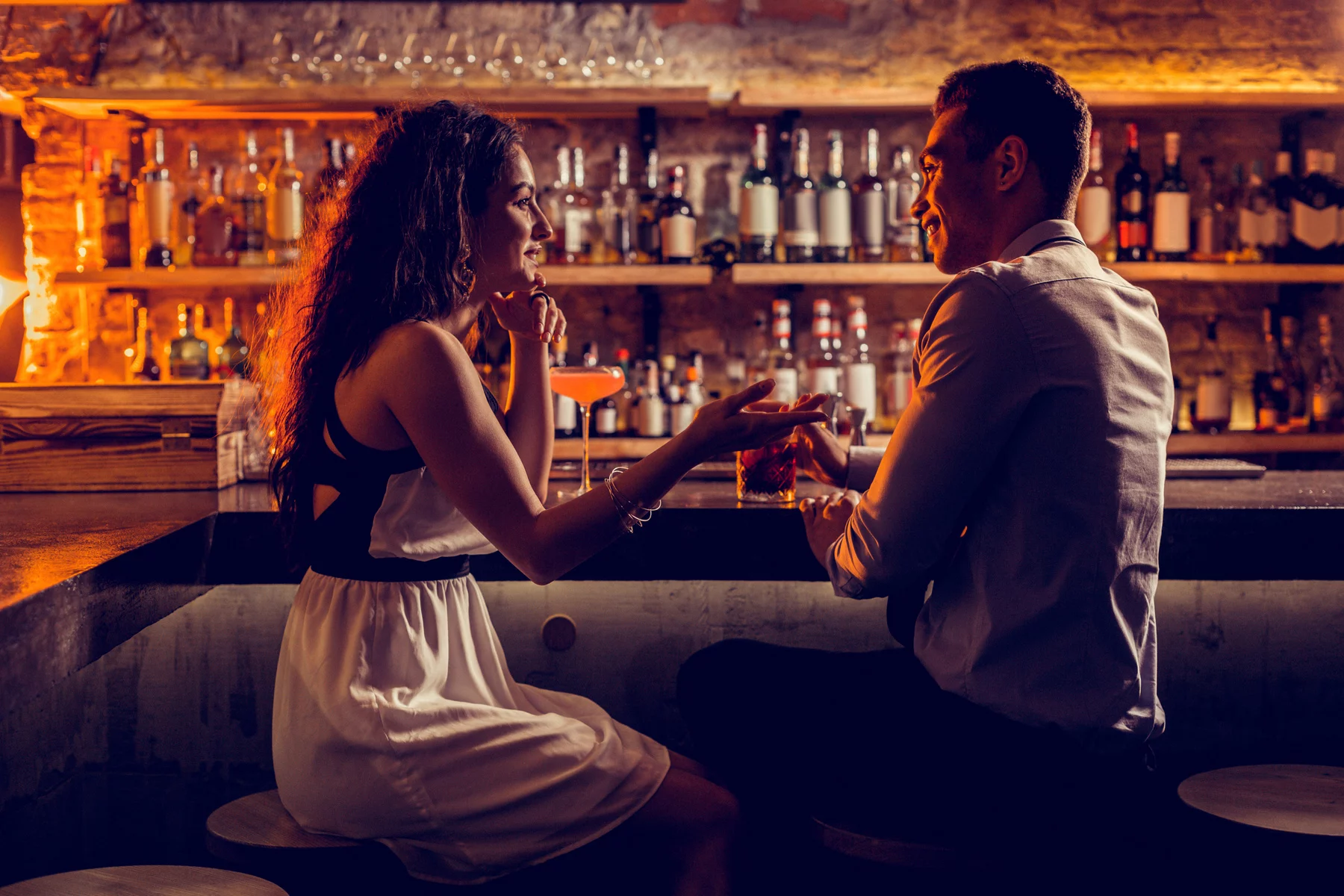 A couple on a date in a cocktail bar