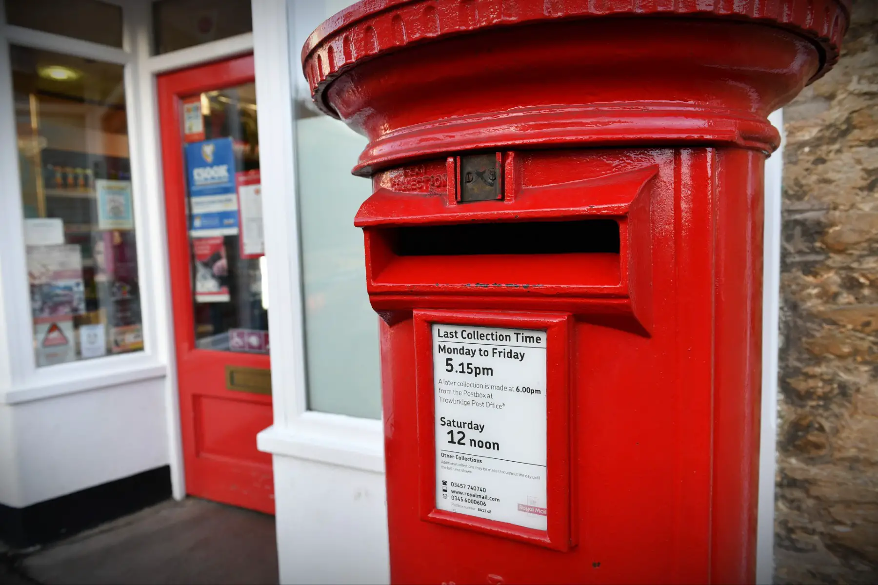 foreign exchange brokers: a Royal Mail red pillar box outside a Post Office in Frome, UK