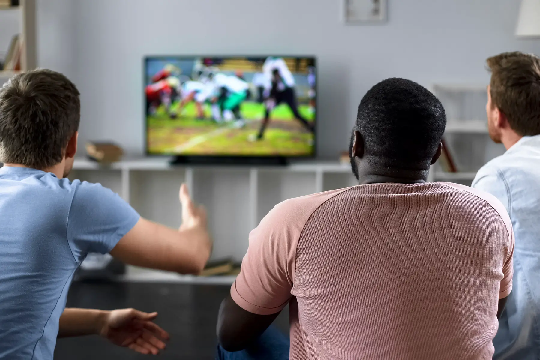 Friends watching American football on TV