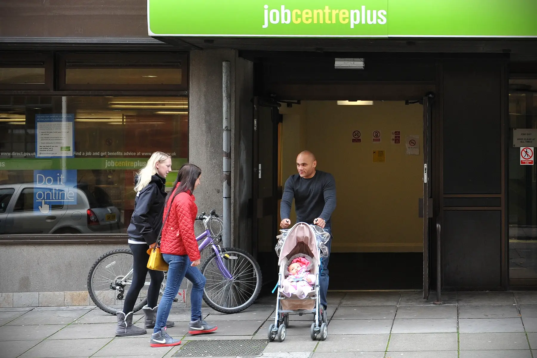 People entering and exiting a Jobcentre Plus in Bath