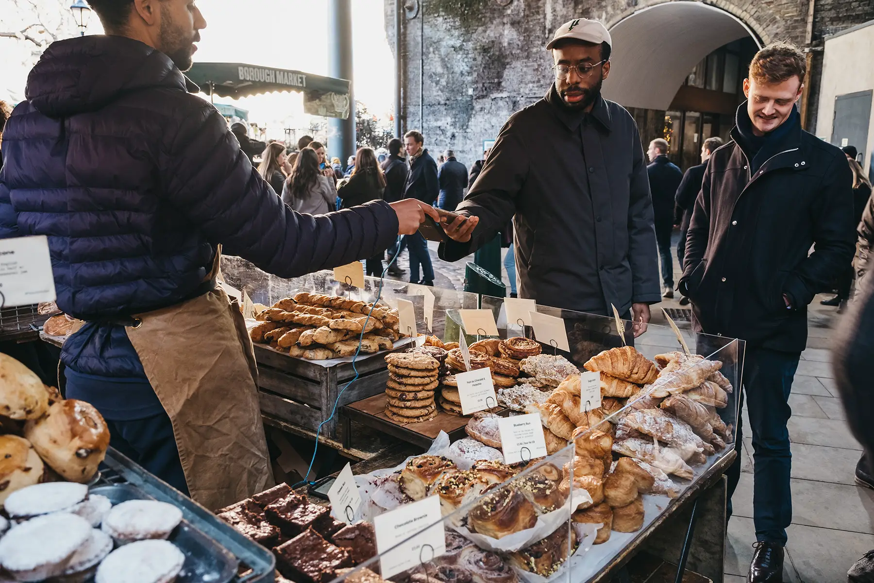 A man makes a payment with his mobile phone at a market in London