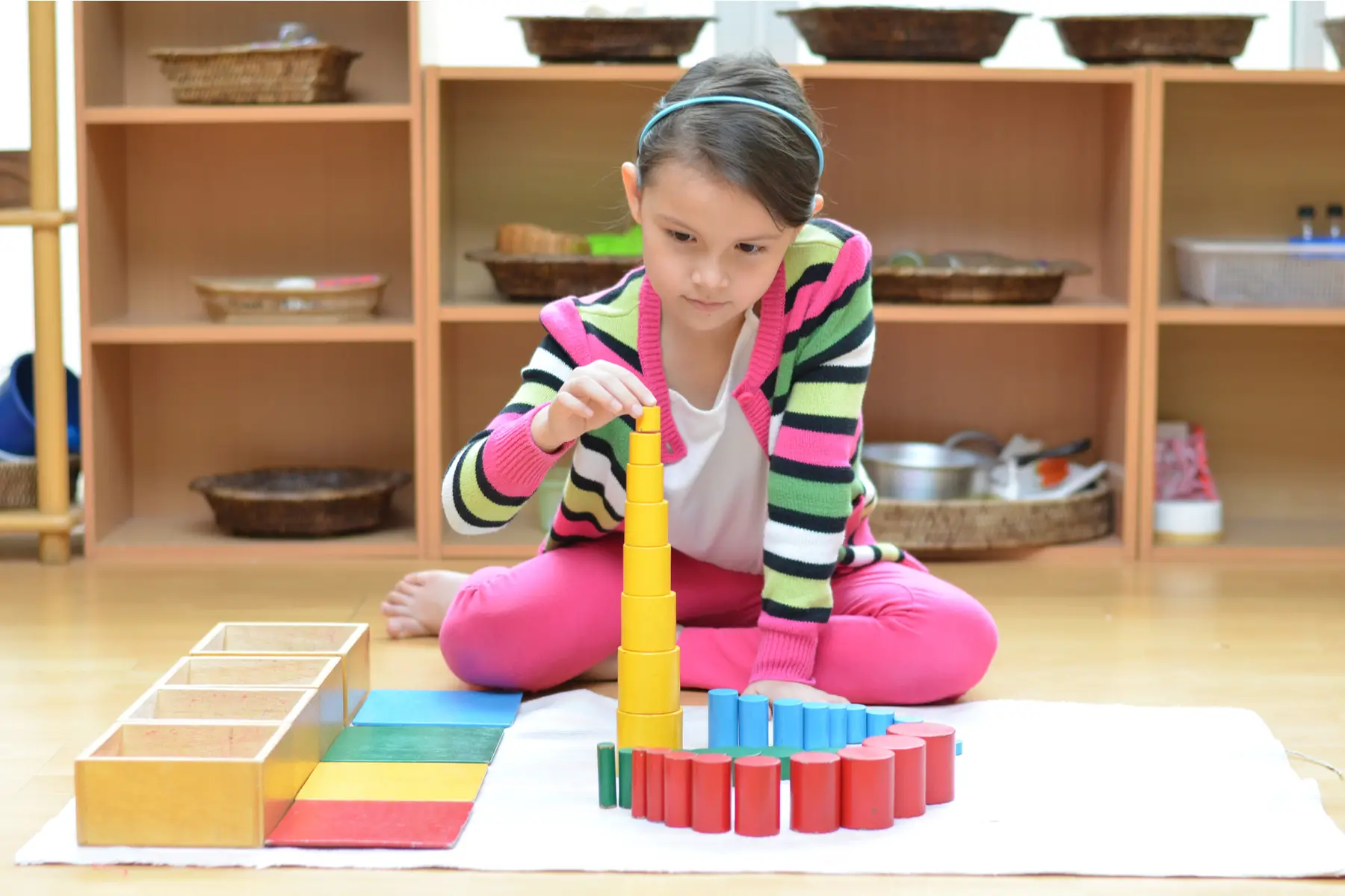 UK education system - child working with Montessori materials in class