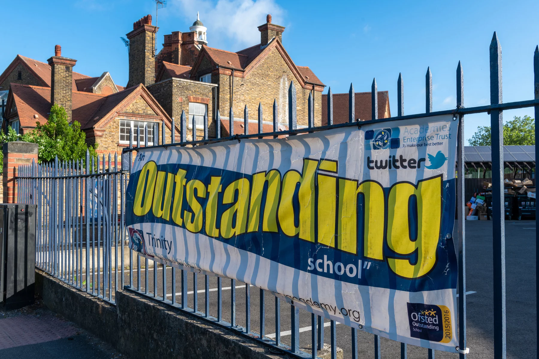 Outstanding Ofsted banner on Trinity Academy school gate to show their quality of education