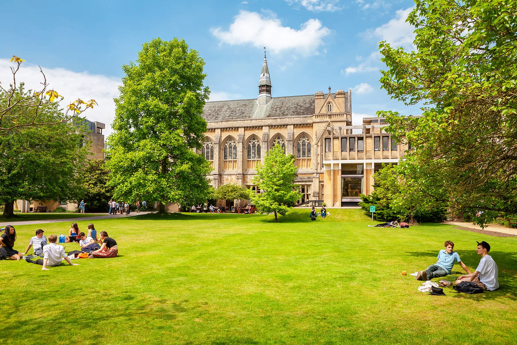 Students sitting on lawn at the University of Oxford