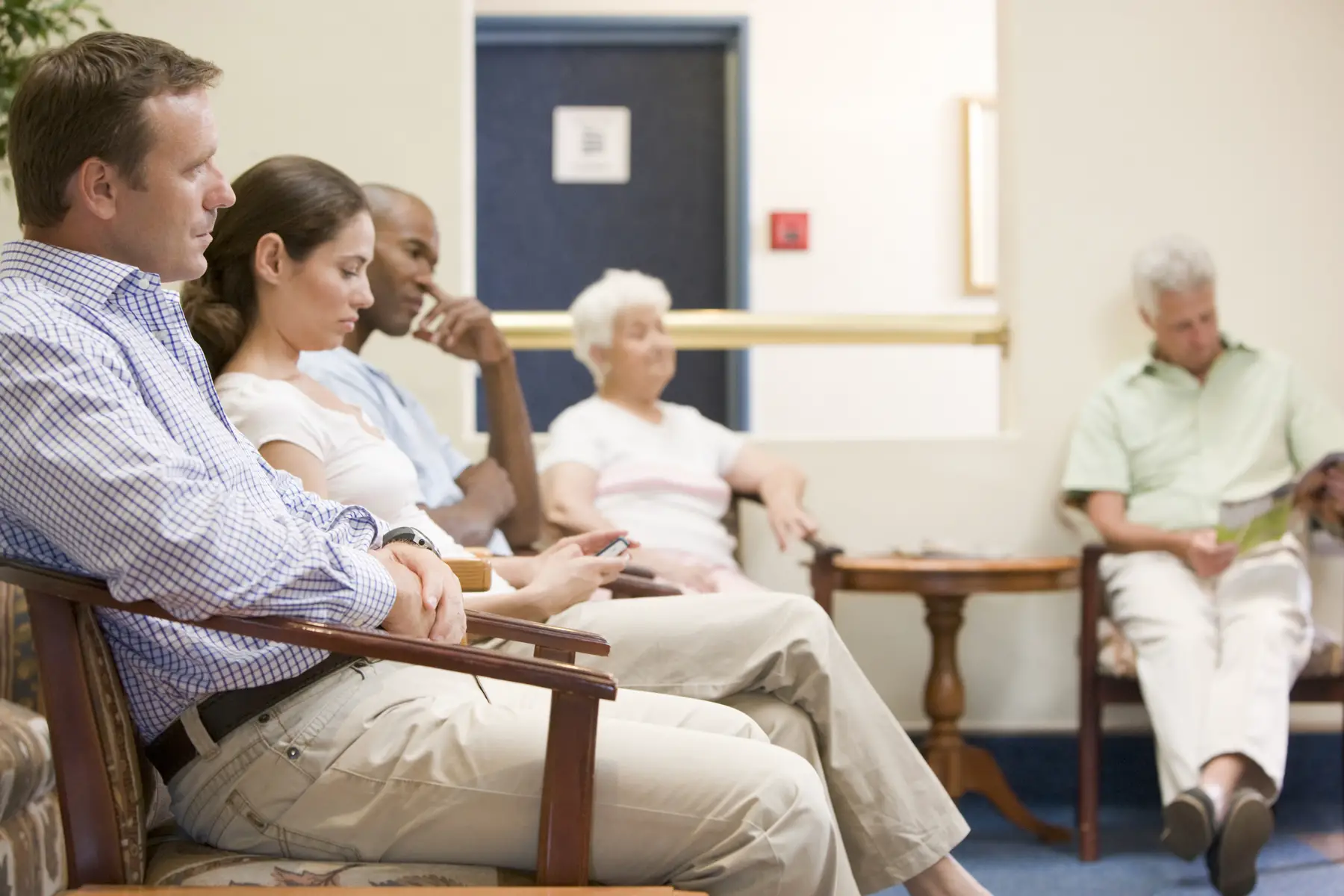 Patients waiting in a GP's waiting room