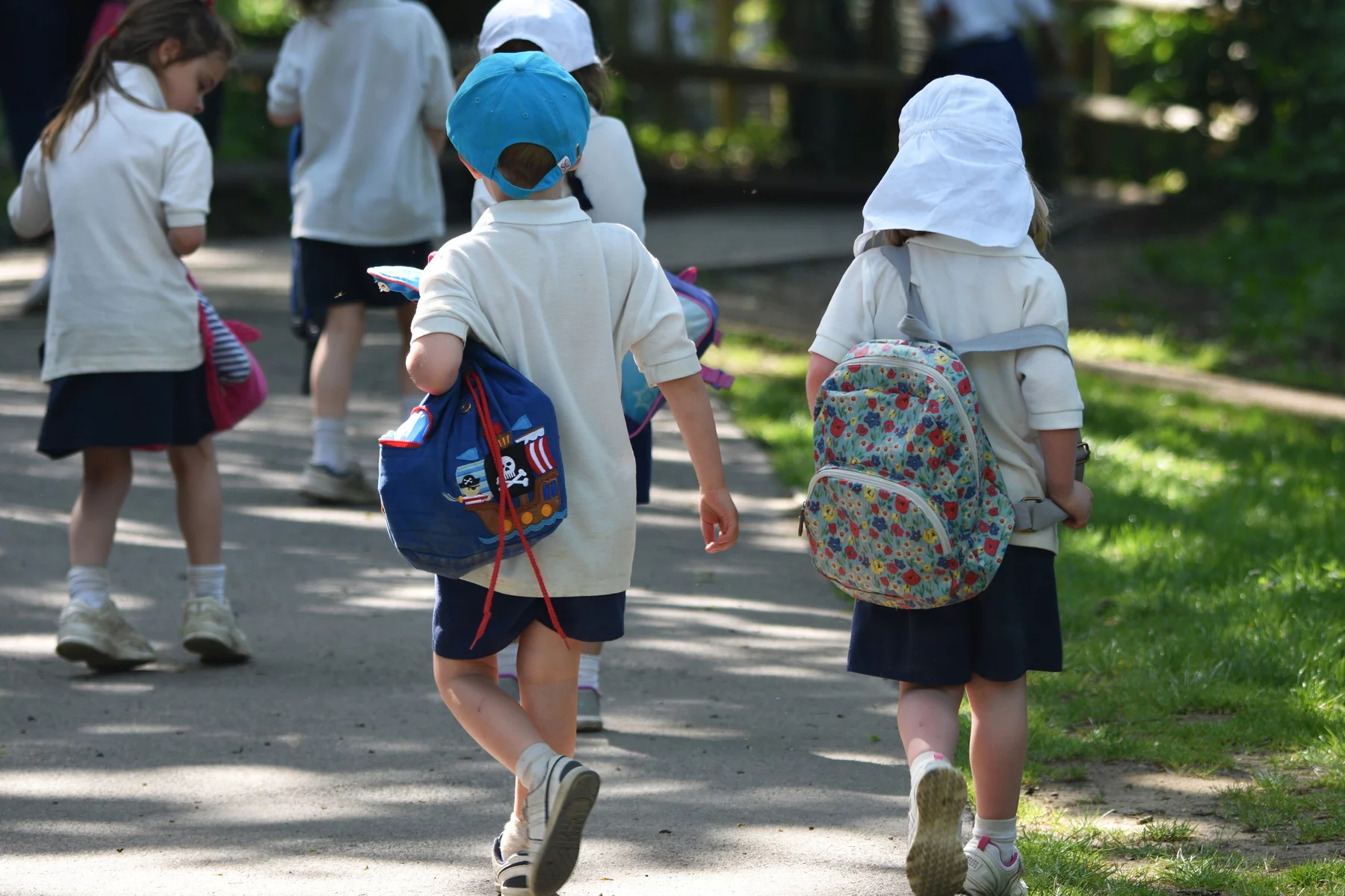 Primary school in the uk, children on a field trip, walking with small backpacks