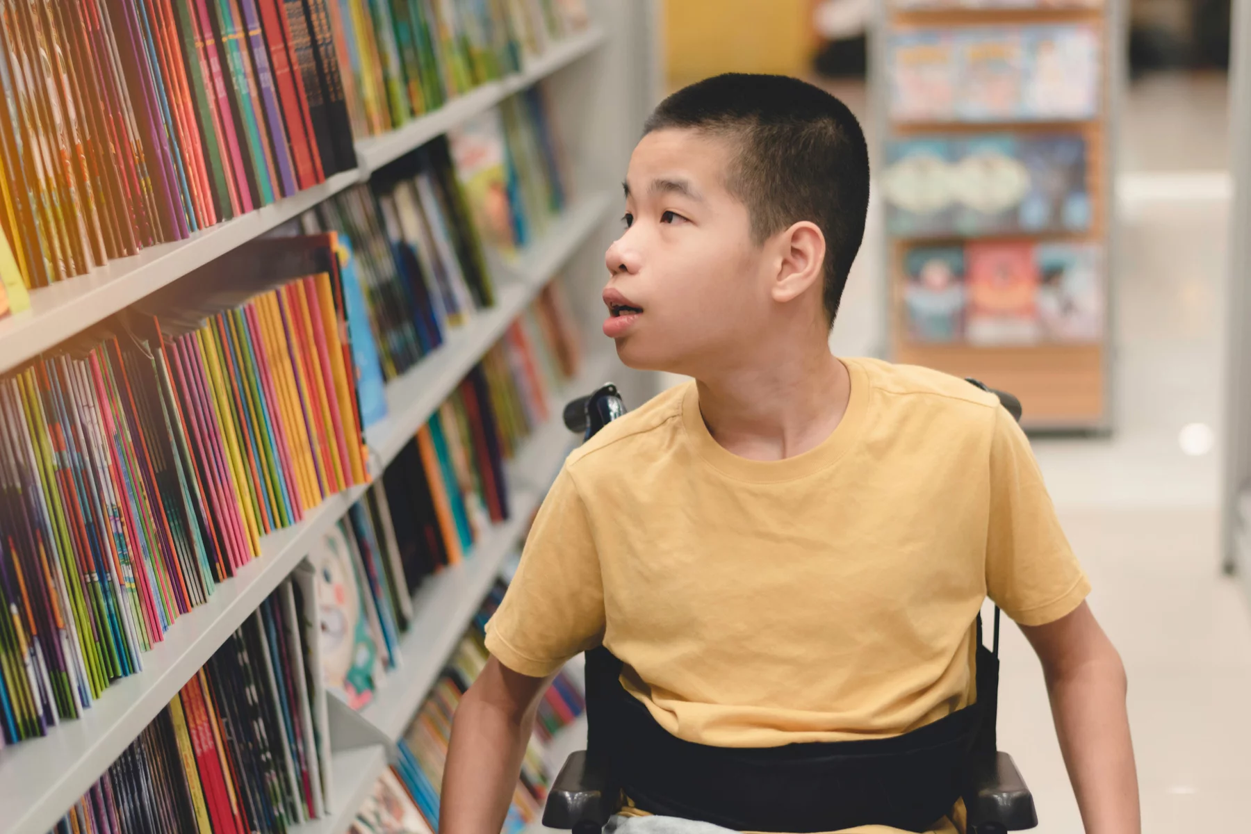 SEN student in a wheelchair at a school library