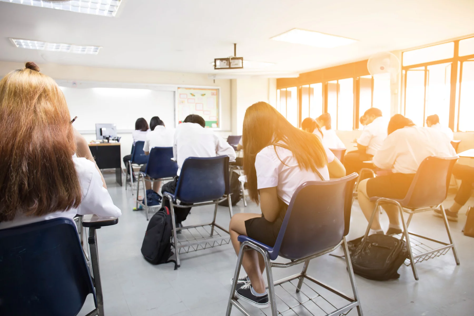 rows of students at desks in class, uk education system