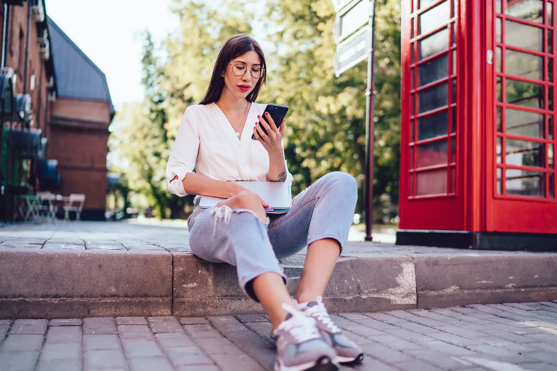 Woman using an app on her phone in London, UK