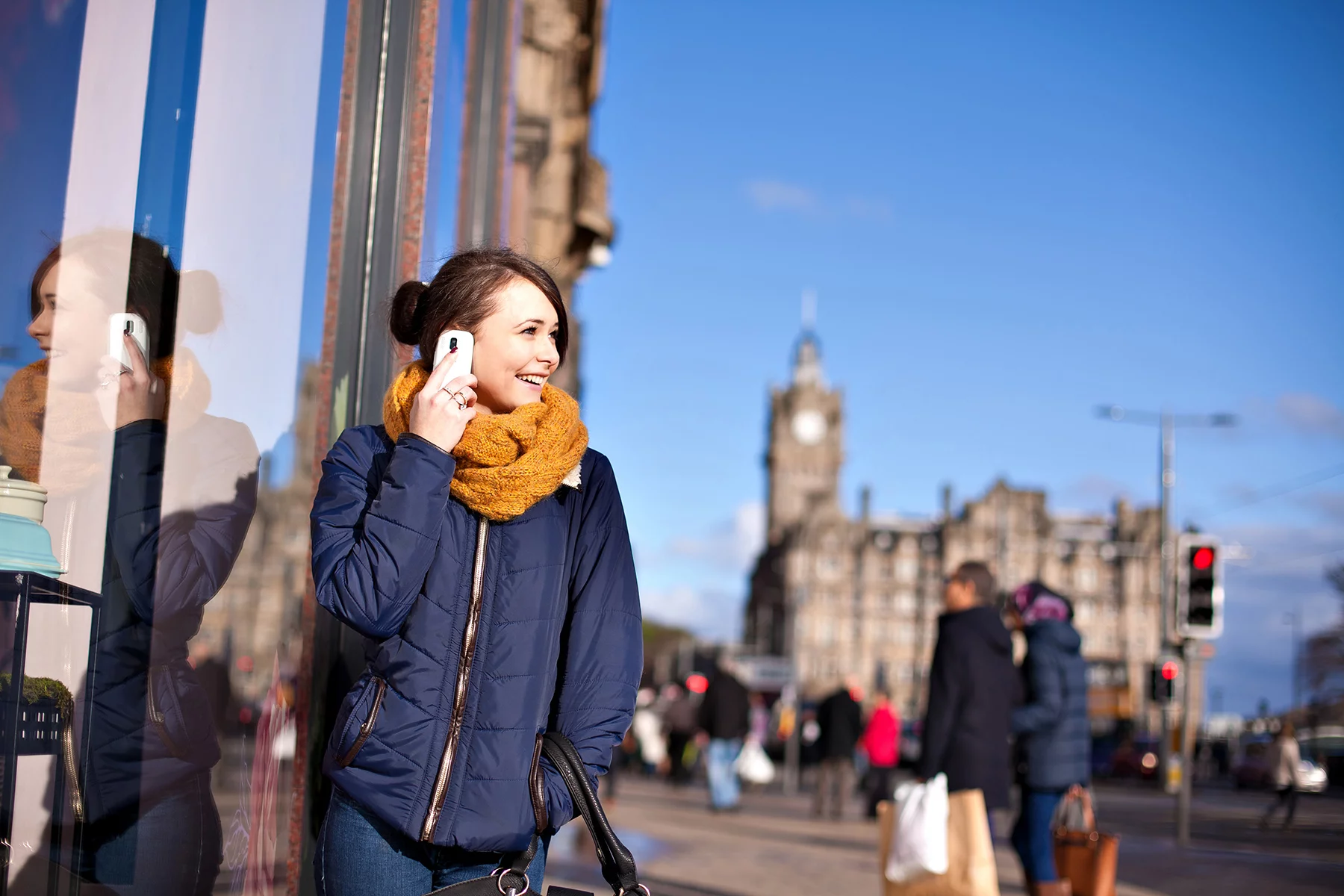 Woman taking a call on her mobile phone in Edinburgh, UK