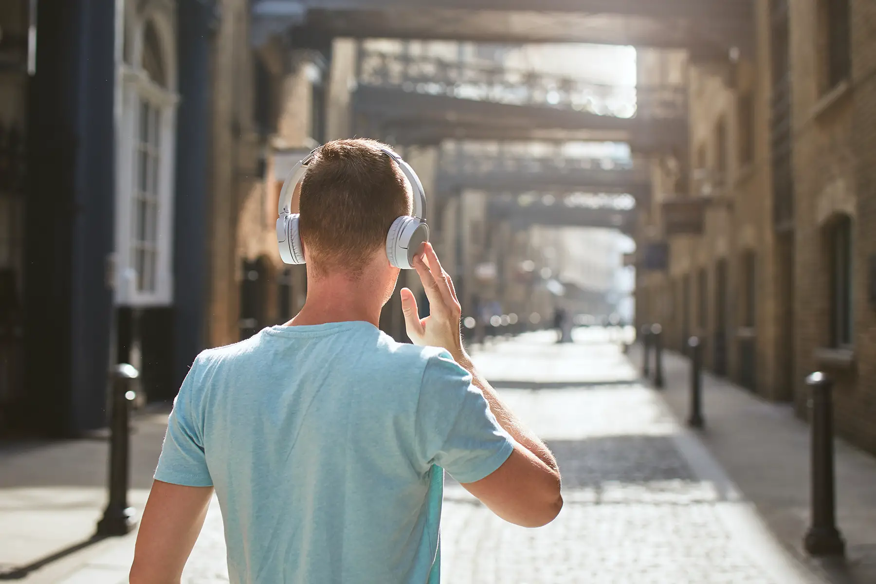 Young man listening to music on a street in London