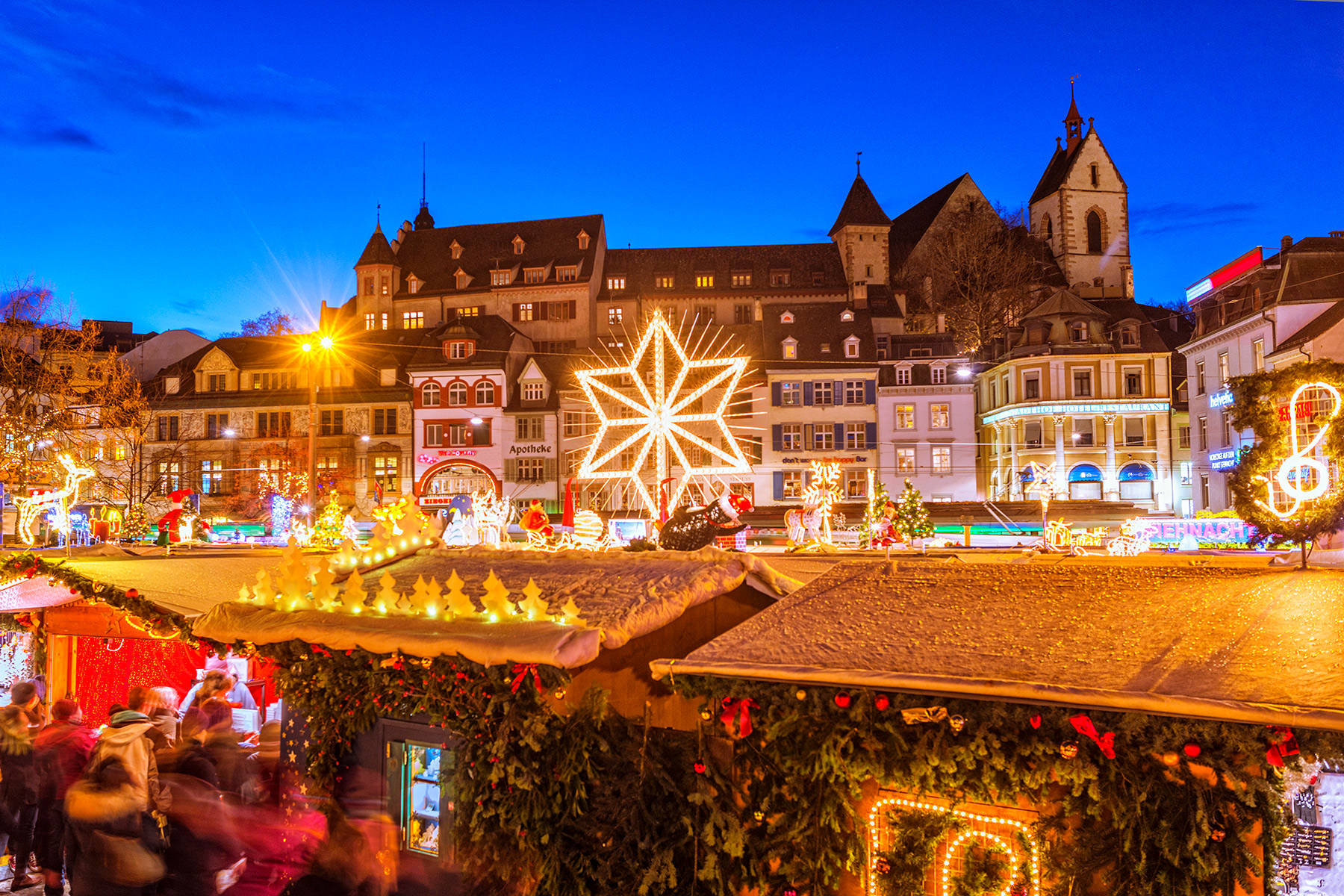 View over the Christmas market at the Bafüssplatz in Basel at dusk