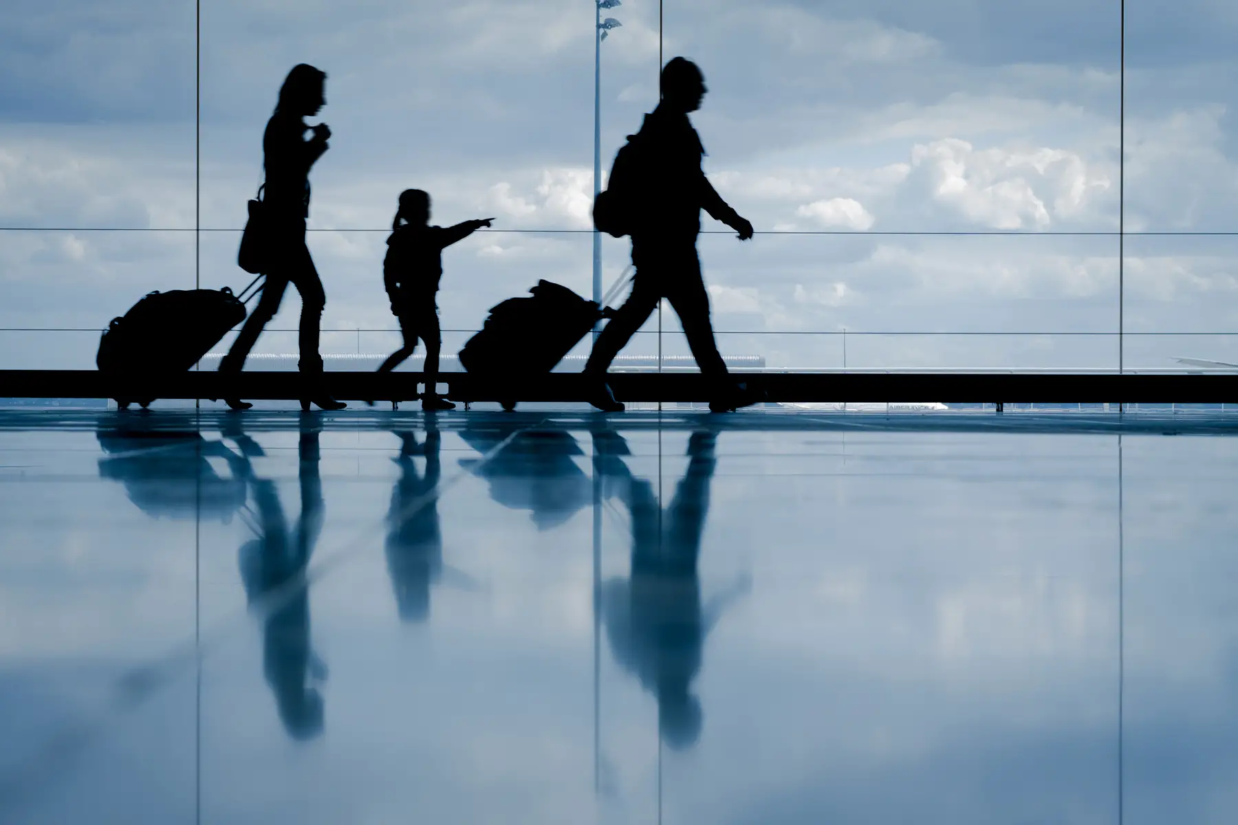 Family walking through an airport