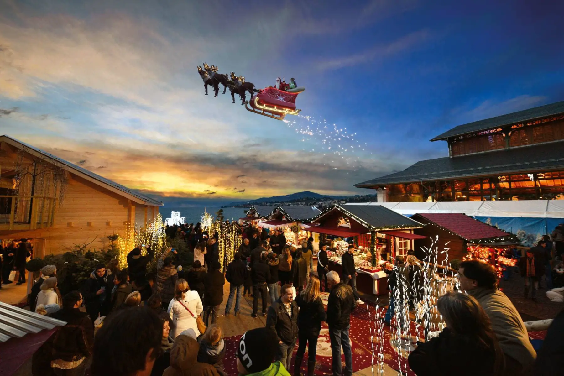 Santa flying his sleigh over the busy Christmas market at Montreux Noël 