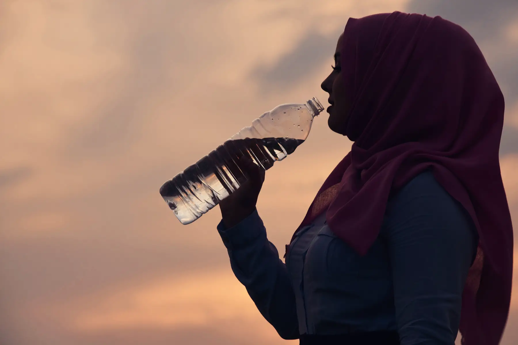 Muslim woman drinking water during Ramadan