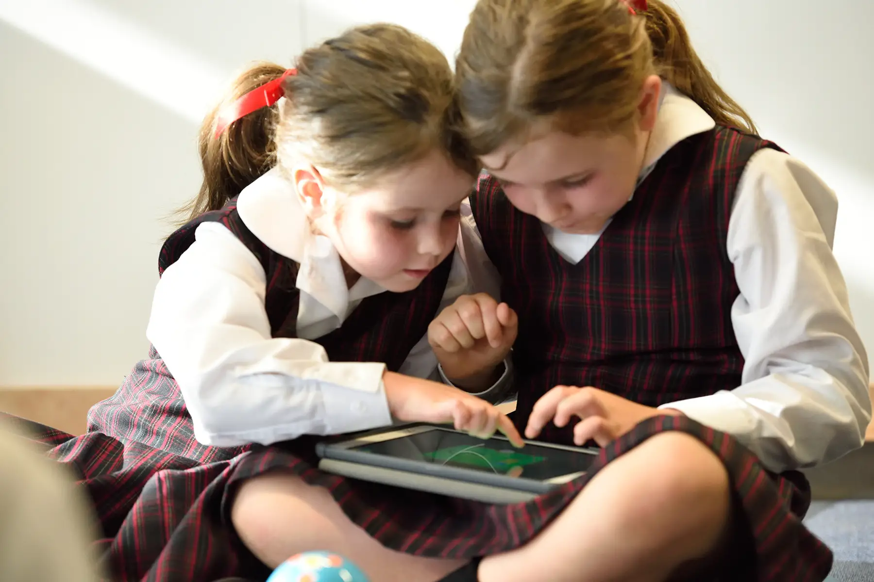 Schoolchildren using a tablet at school