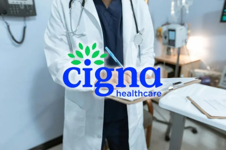 Doctor signing a document with the Cigna Healthcare logo in the center.