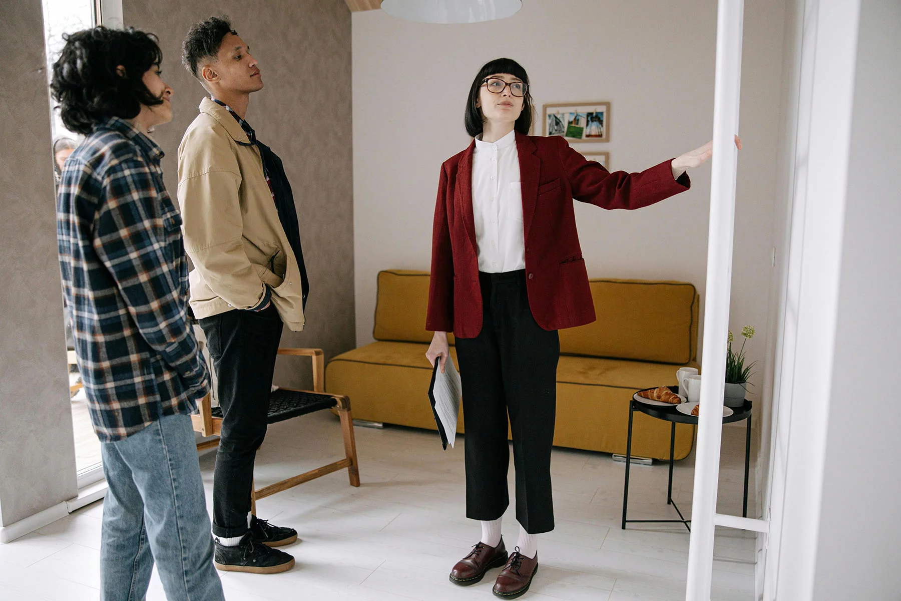 Realtor showing a couple around a rental house.