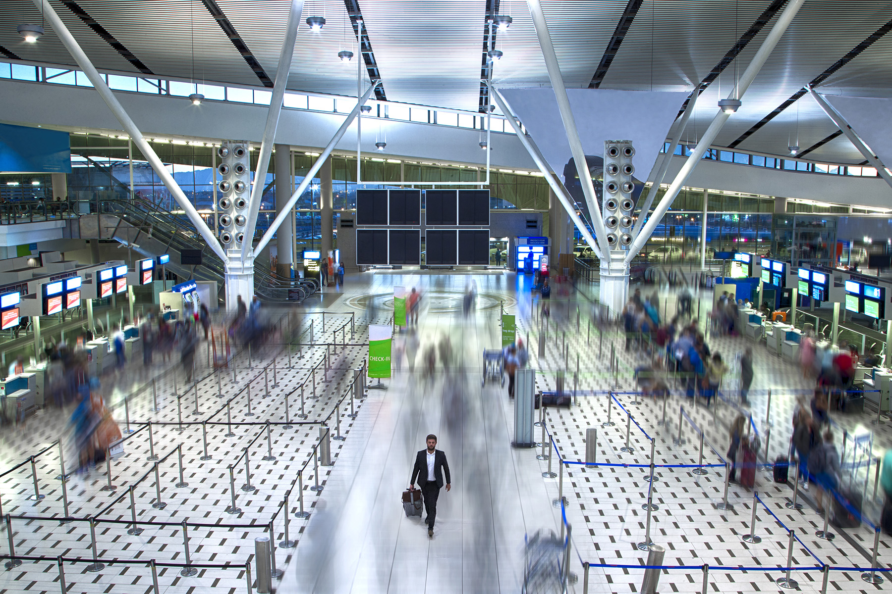 Wide, high angle shot of an airport terminal building with a motion blur effect
