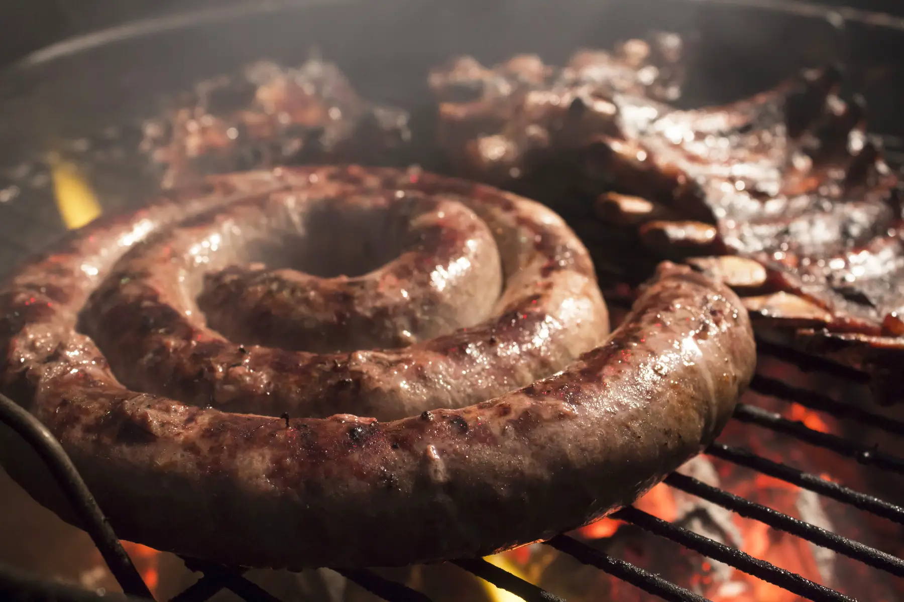 South African boerewors grilling on a braai