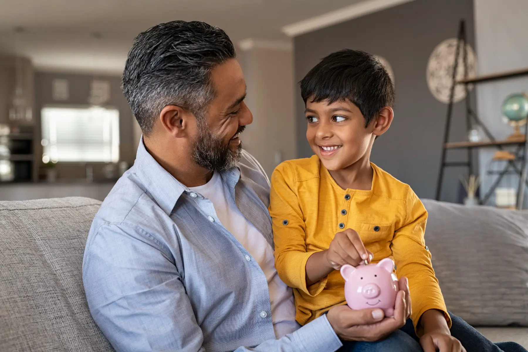 father and son with a piggy bank, South African bank account
