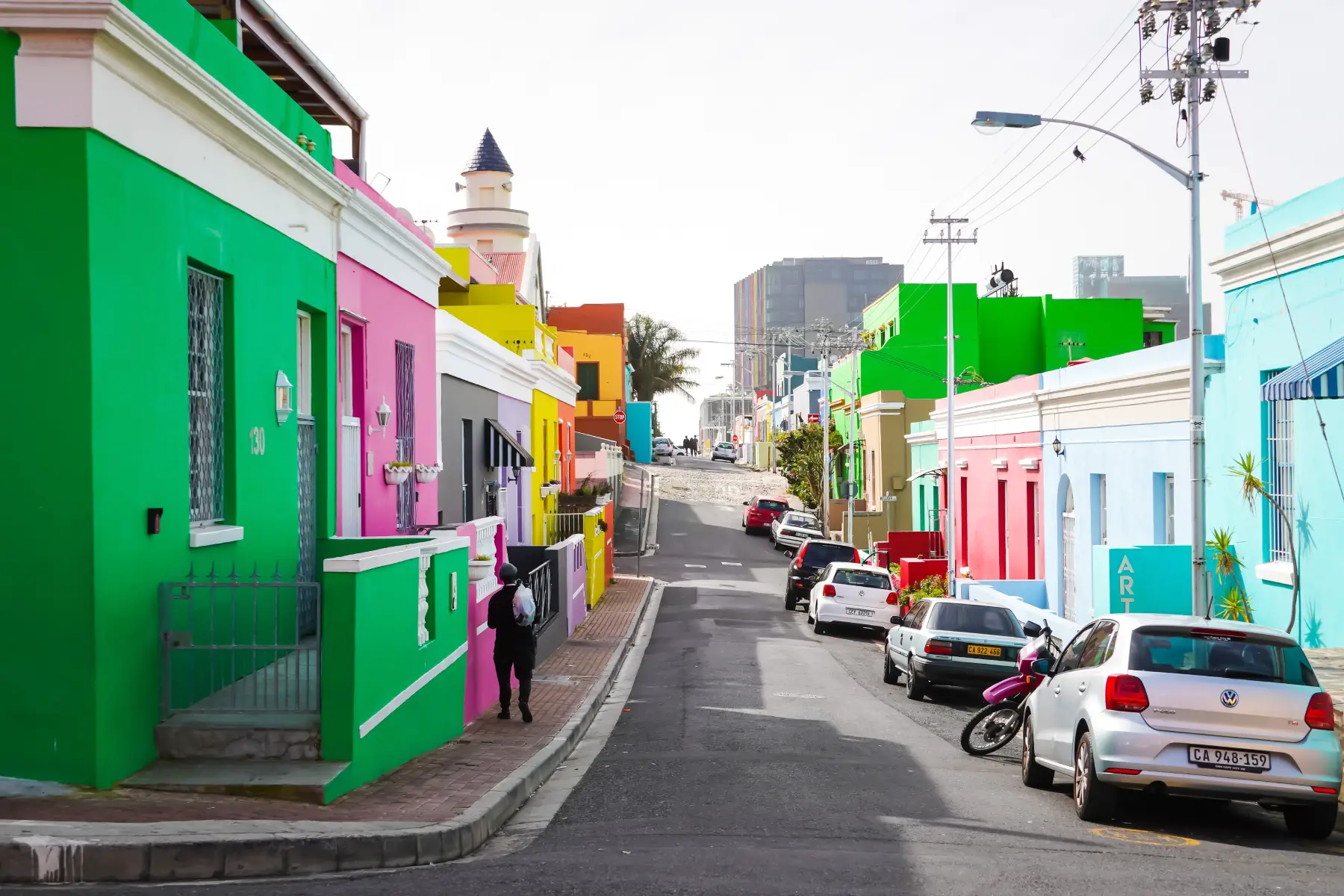 Colourful houses on a street in the Bo-Kaap, telephone lines are visible
