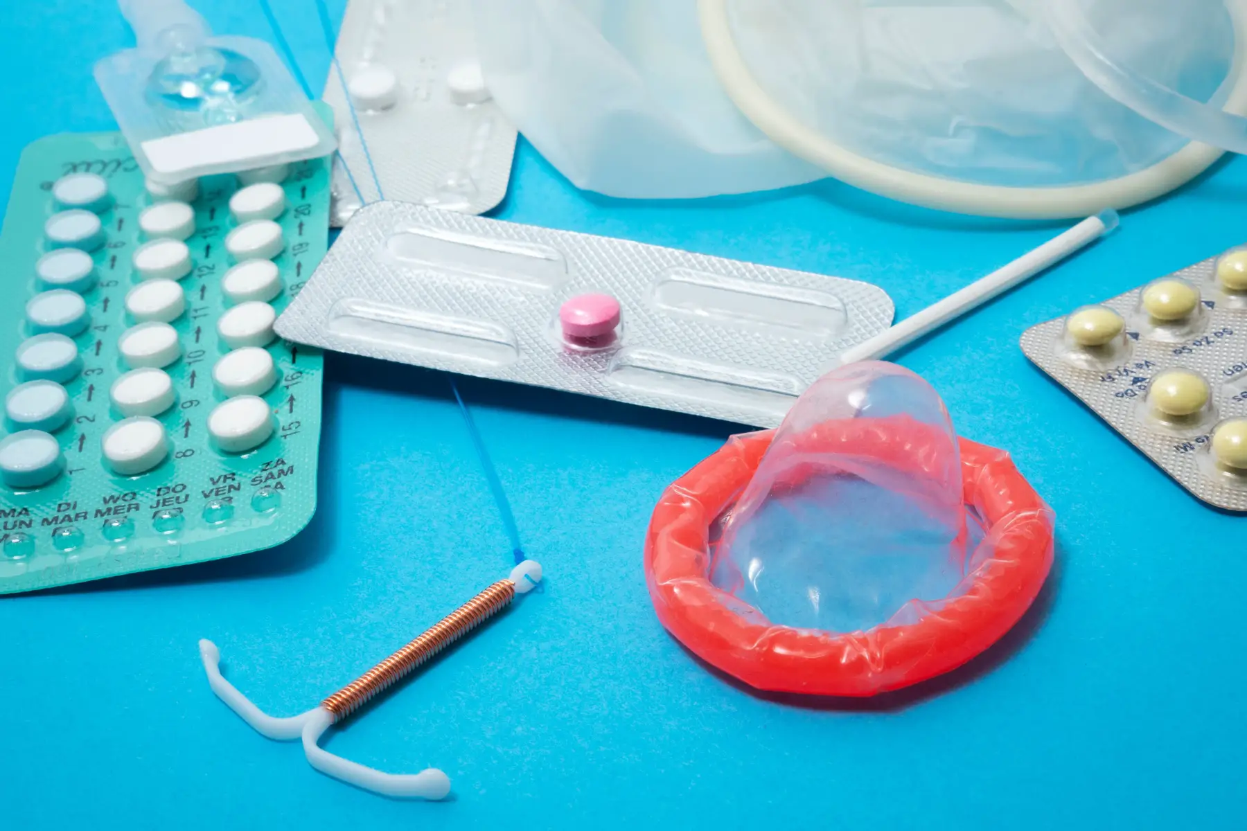 Different contraceptive items on a blue background