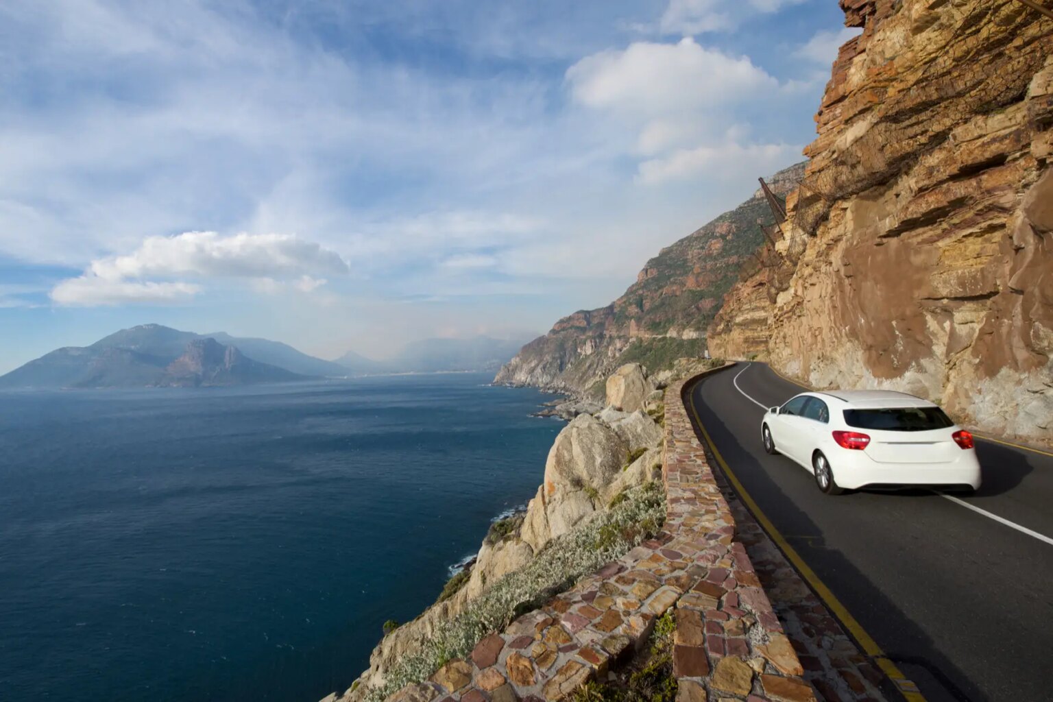 A car drives along Chapmans Peak in South Africa