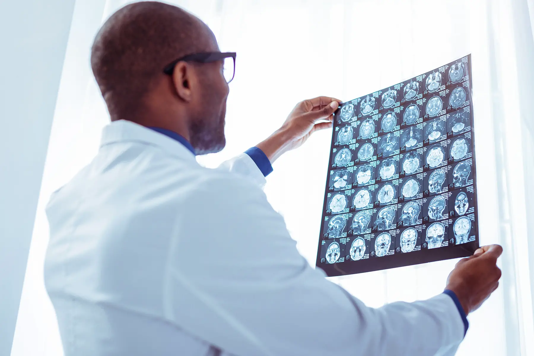 Oncologist examining brain scans