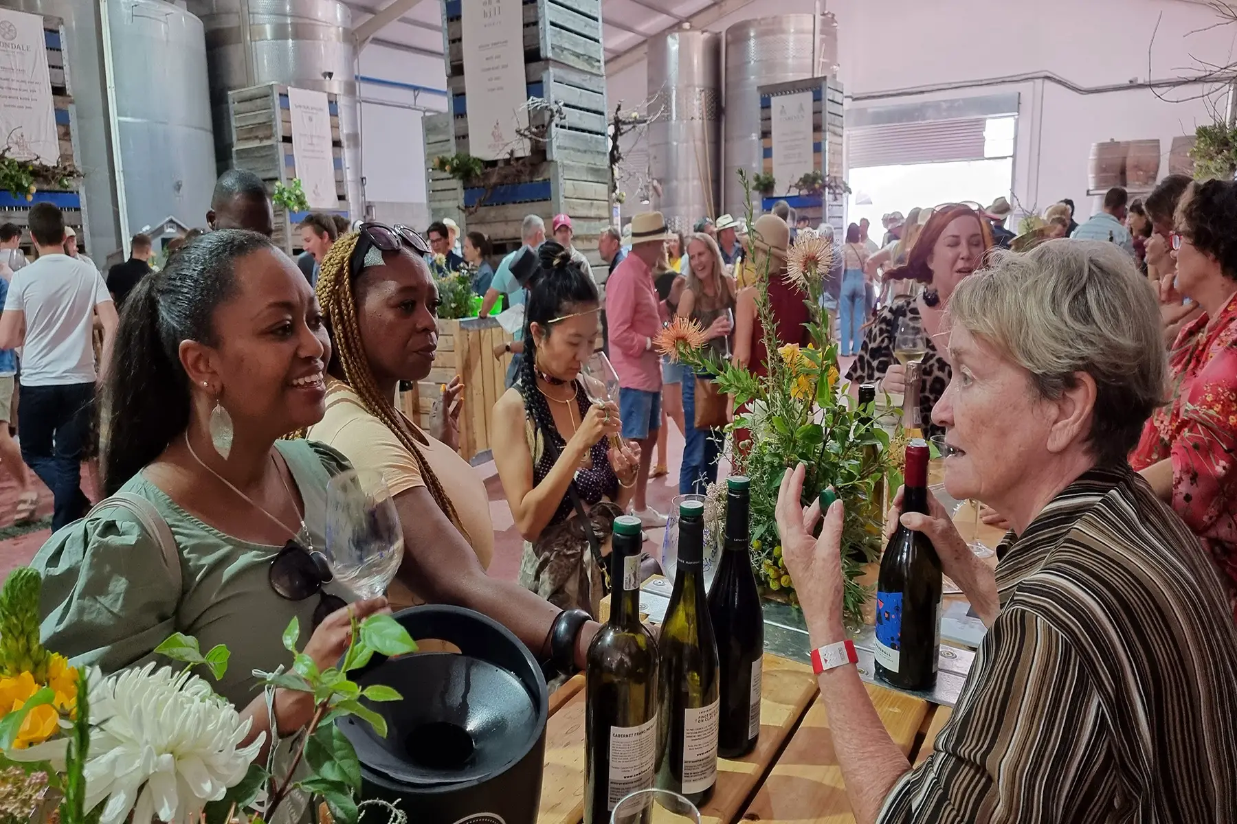 A diverse group of South Africans tasting wine at the South African Wine Festival neat Stellenbosch