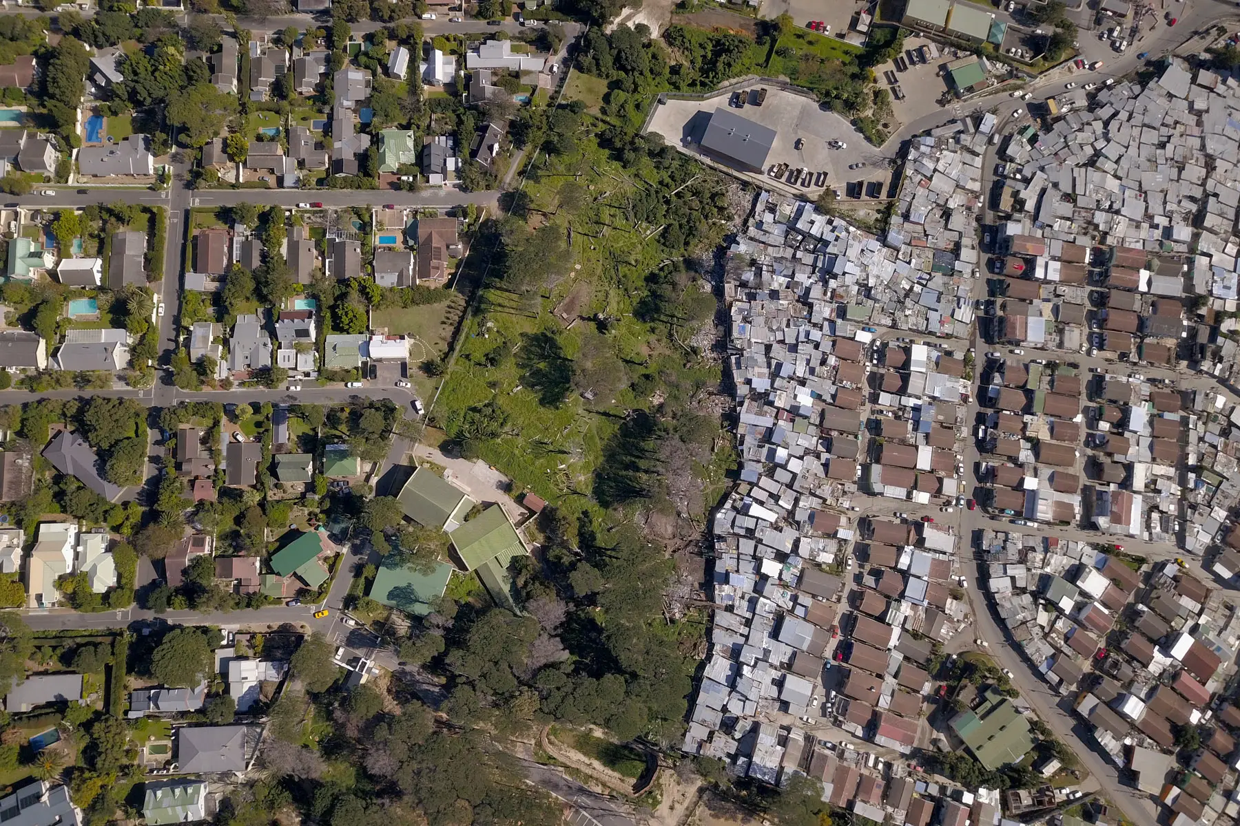 aerial view of a wealthy suburb and neighboring a low-income/social housing township in South Africa
