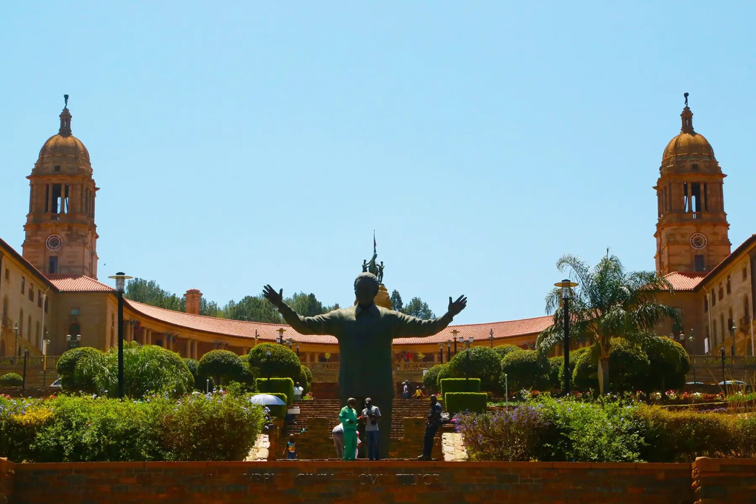 Wide shot of the Union Buildings in South Africa with a statue of Nelson Mandela